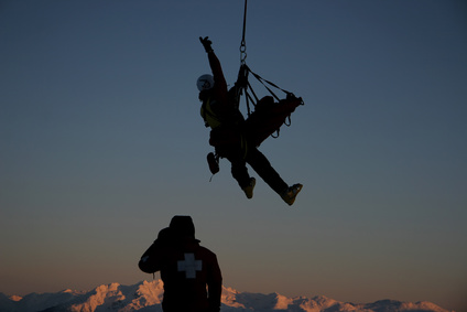 A mountain rescue team prepares for a helicopter rescue.